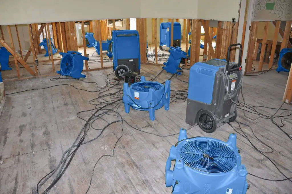 Air movers drying a gutted El Cajon room after major water damage
